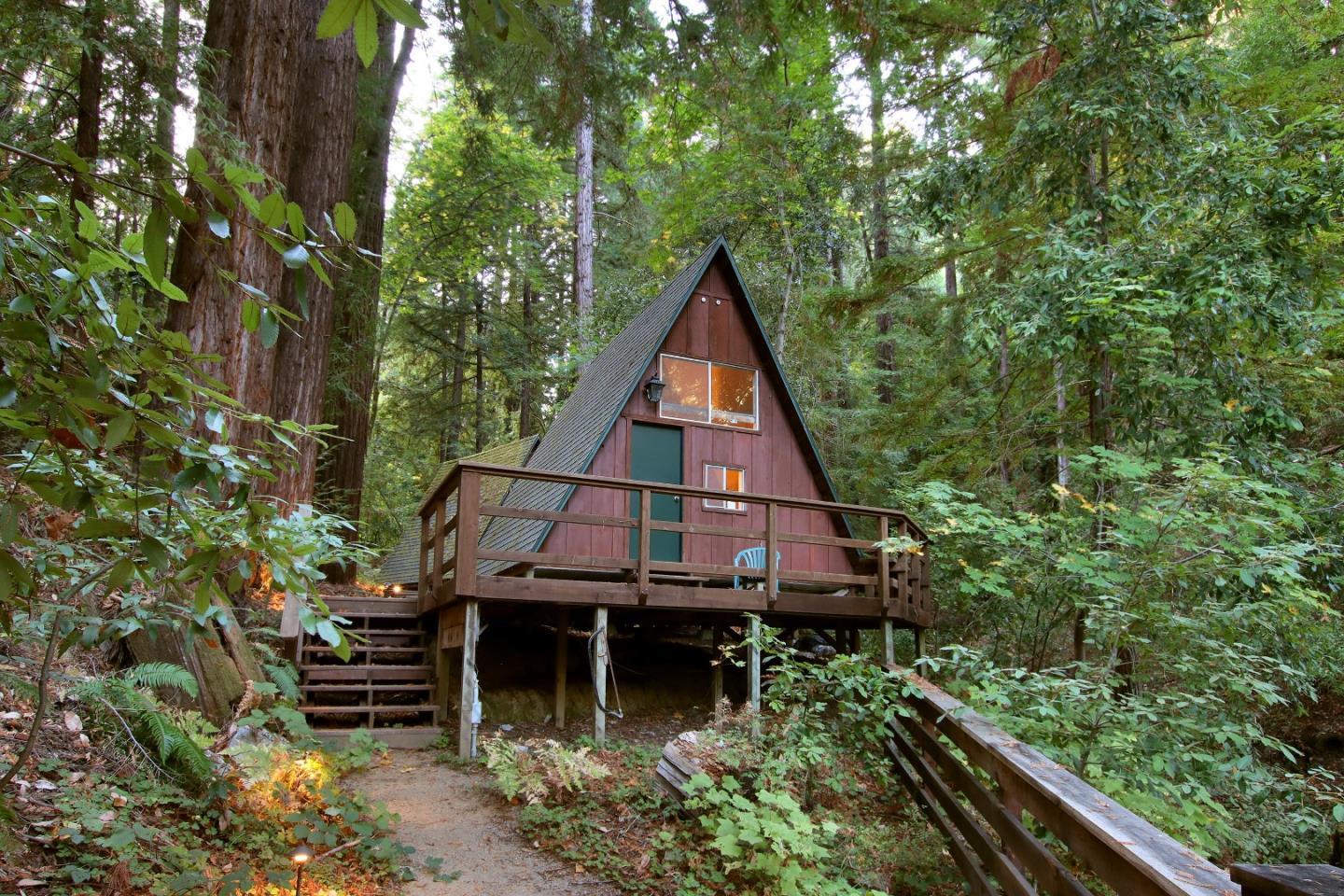 An A-frame cabin and deck among the redwoods at Laurel Mill Lodge.